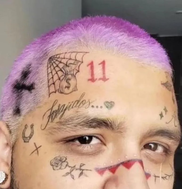 Image of Christian Nodal's face tattoos
